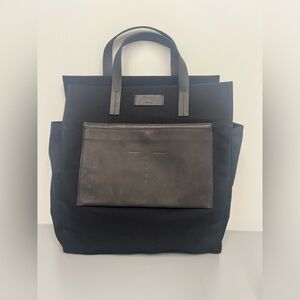 Theory Black Canvas Shopper Bag with a duffle bag.